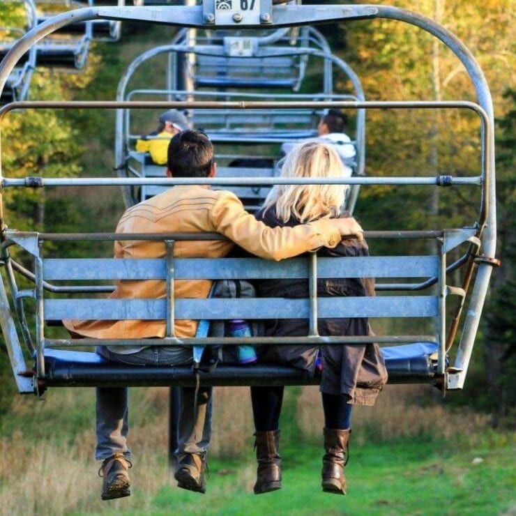 man and women riding a chairlift